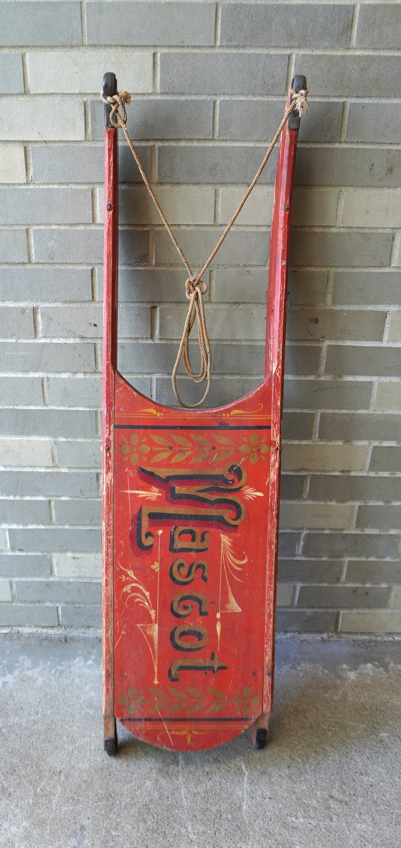 A child's sled in original red paint and stenciling, marked "MASCOT" with shadow lettering and hand: A child's sled in original red paint and stenciling, marked "MASCOT" with shadow lettering and hand forged iron runners. Some paint wear, otherwise good condition, 19th century. Measures 45 1/2"L x 11