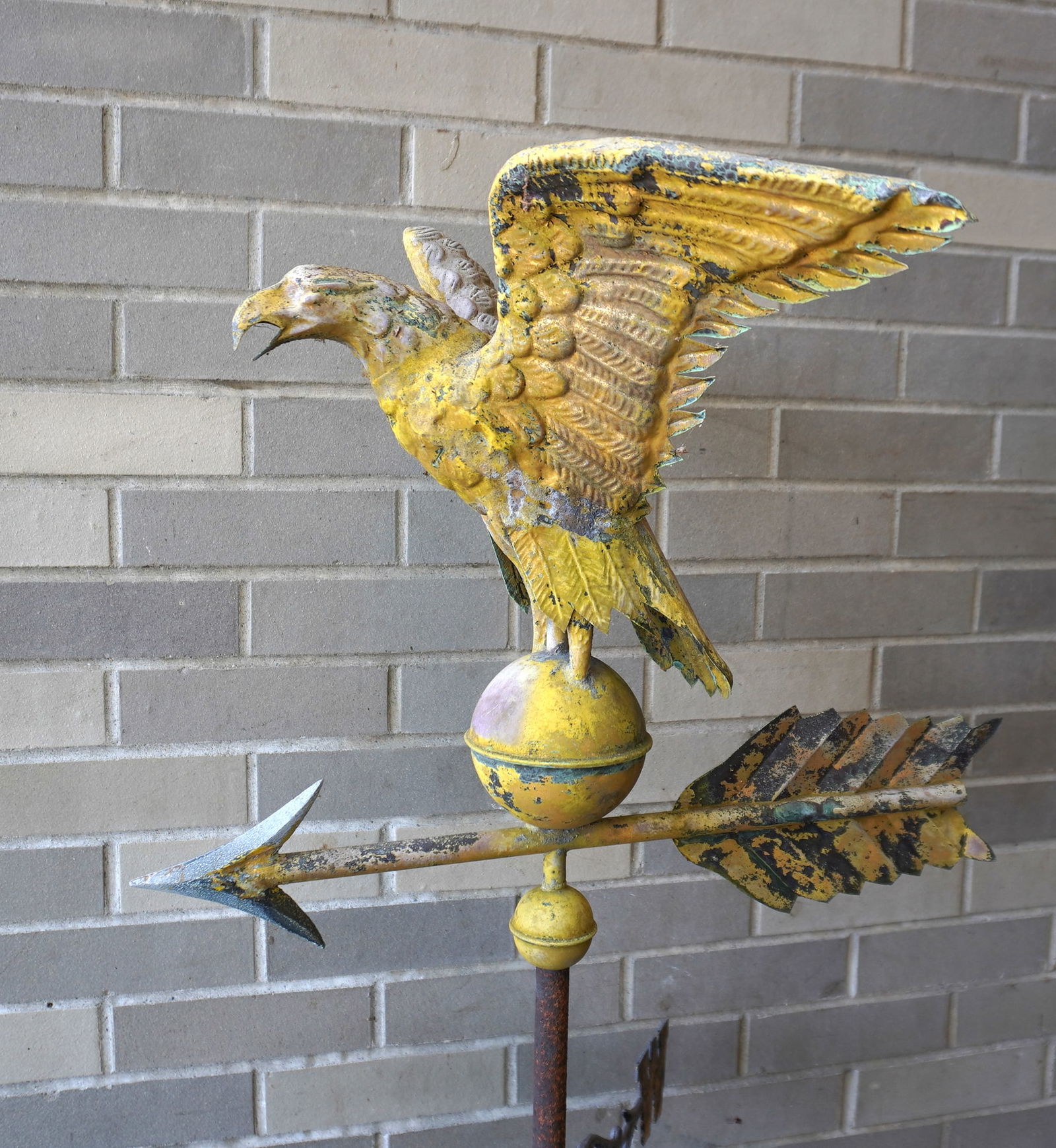 A very fine full body spread wing eagle weathervane in gold paint that appears to be original. The: A very fine full body spread wing eagle weathervane in gold paint that appears to be original. The eagle is mounted on arrow with zinc point, above copper orb and retains original rod and directionals