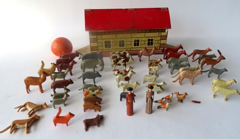 A Noah's Ark toy with hinged roof and flat bottom that contains many pairs of hand carved and