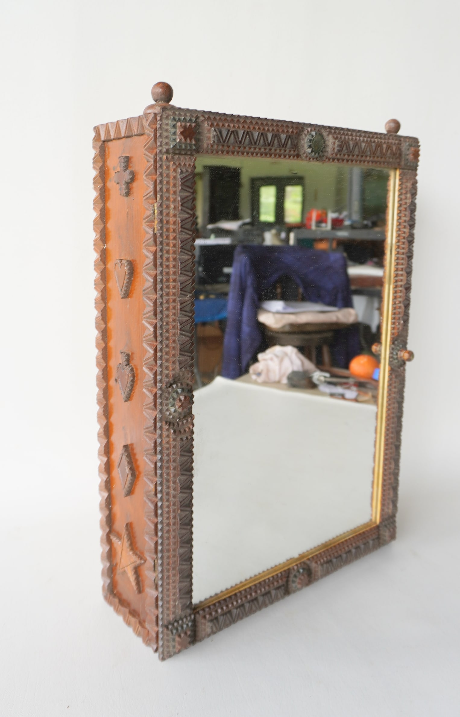 A tramp art medicine cabinet with mirror door and 2 interior glass shelves, late 19th to early 20th: A tramp art medicine cabinet with mirror door and 2 interior glass shelves, late 19th to early 20th century. Missing small piece top center, else very good condition. Measures 14 3/4"W x 5 1/2"D x 21 