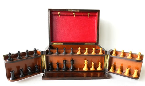 An outstanding rosewood boxed wooden chess set and checker set with fitted interior holding pieces.