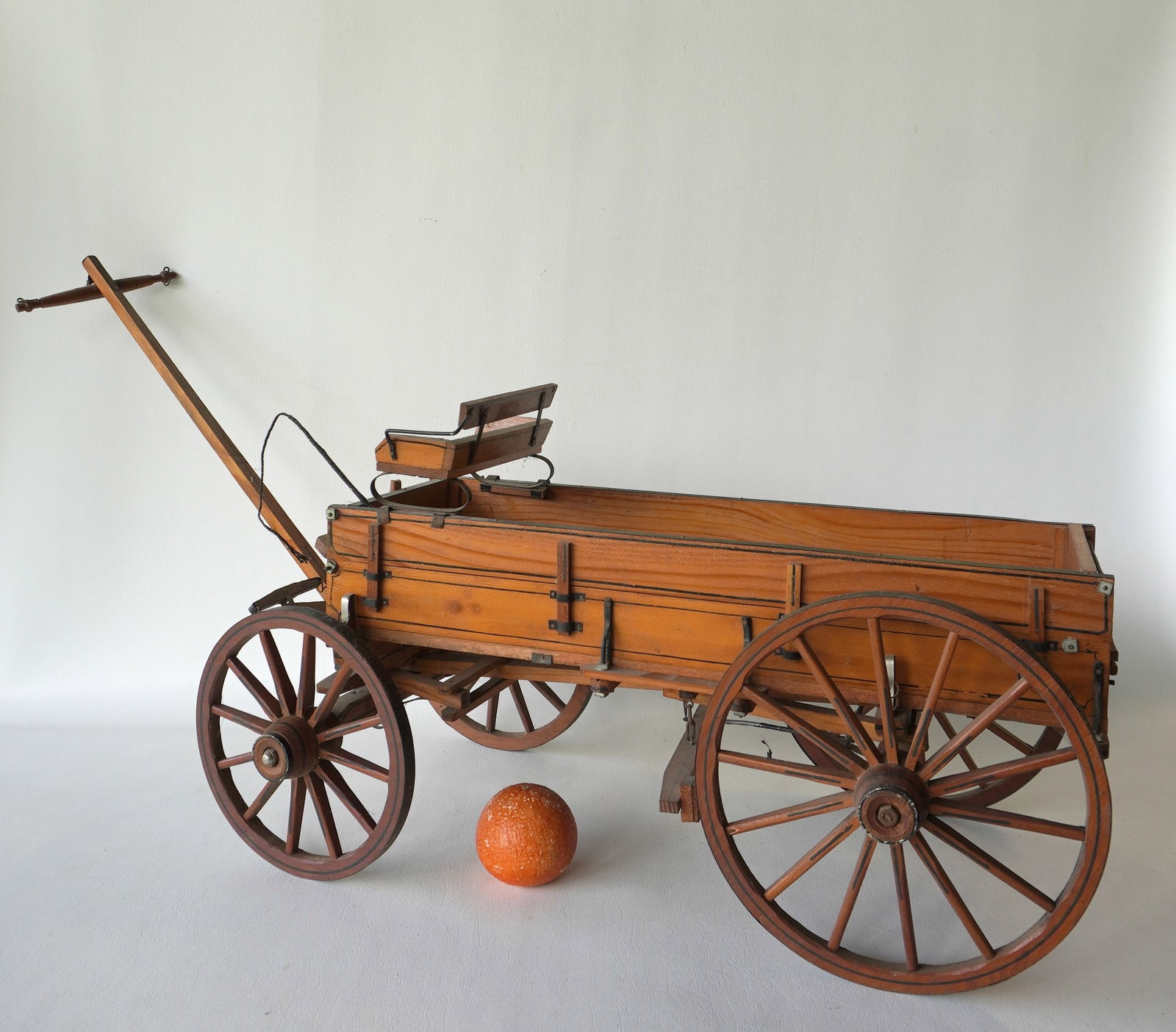 A horse drawn freight wagon model, possibly salesman sample, original pin striping, removable sides: A horse drawn freight wagon model, possibly salesman sample, original pin striping, removable sides and seat, horse whip, wooden wheels, and shaft. The part in the top center of the wagon that would h
