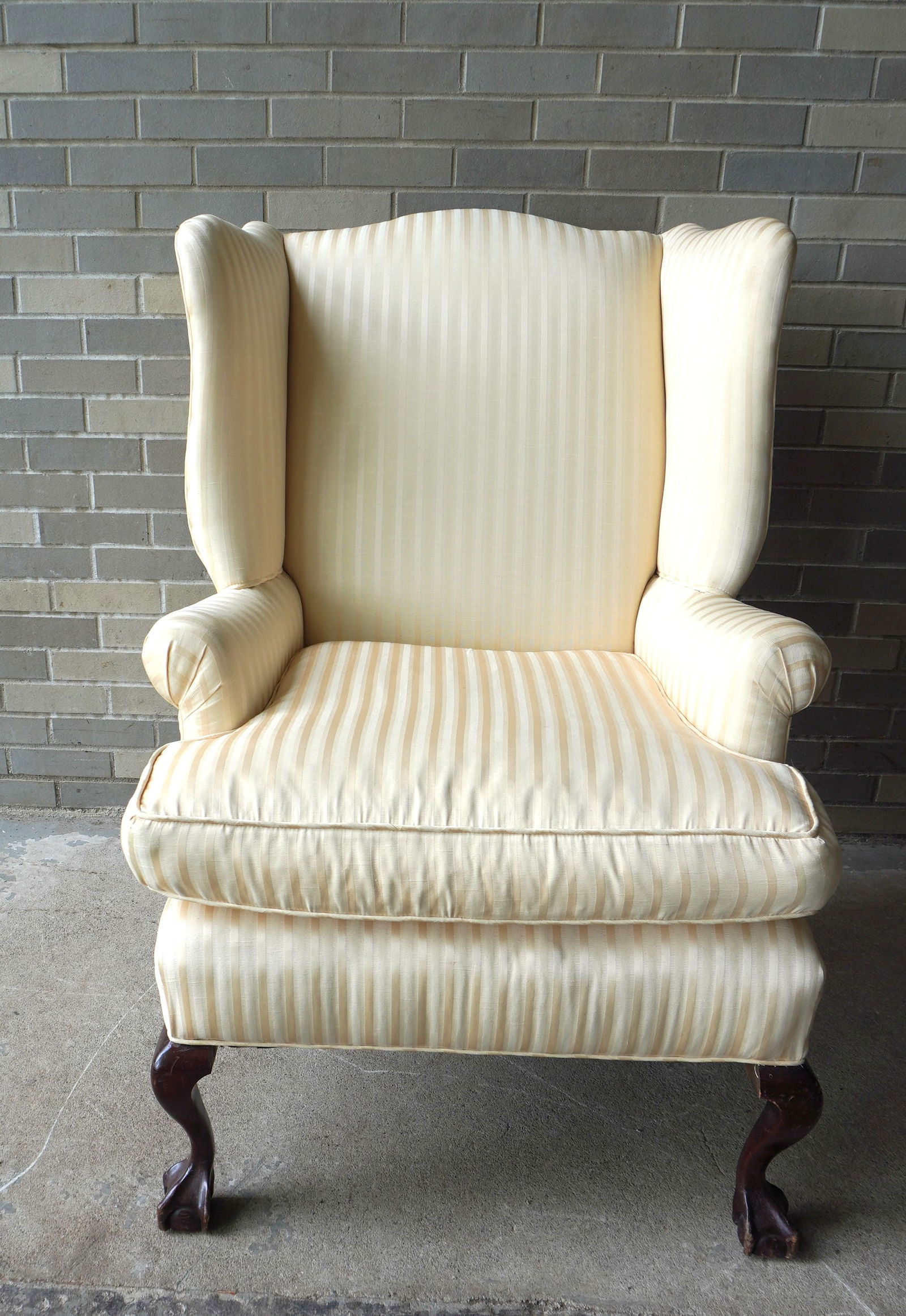 A Chippendale style wing chair, down filled, claw and ball feet, circa 1900. Newly upholstered in: A Chippendale style wing chair, down filled, claw and ball feet, circa 1900. Newly upholstered in very good condition. Measures 31"W x 44 1/2"H x 39"D x 22"H. Provenance: From an Ulster County NY resi