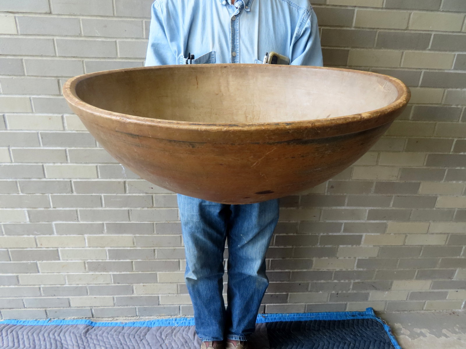 The best monumental primitive treenware bowl with round footed base and molded edge to rim, original: The best monumental primitive treenware bowl with round footed base and molded edge to rim, original surface with traces of original blue/green paint. Circa 1800. Very good condition. Measures 24 1/2"