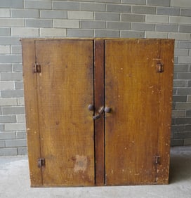 A small 2 door floor cupboard in original paint. The top in yellow and the sides and both doors in