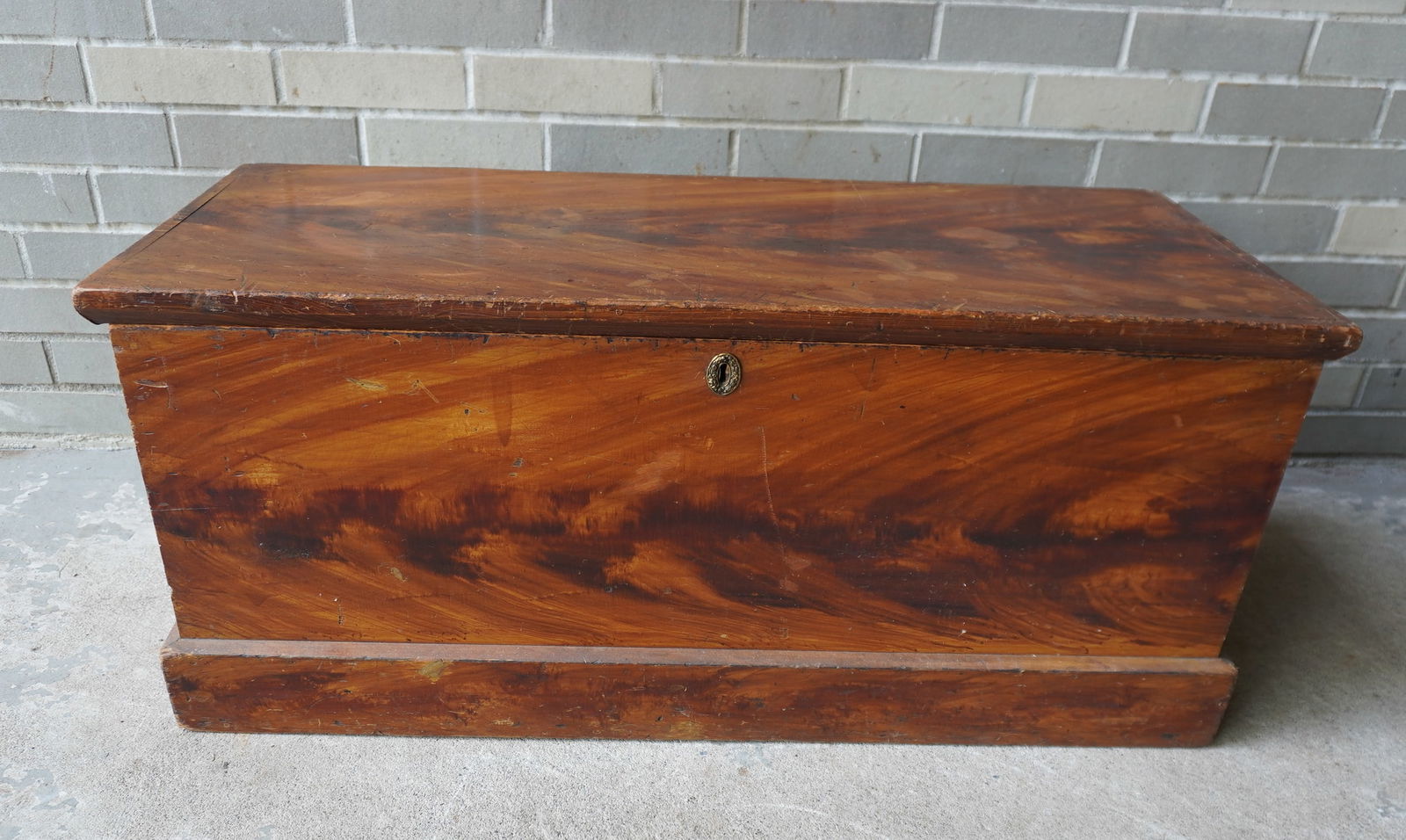 A red/black grain painted Hudson Valley blanket box with interior till and molded base, circa 1850.: A red/black grain painted Hudson Valley blanket box with interior till and molded base, circa 1850. Good condition. Measures 37 1/2"W x 16 1/2"D x 16 1/2"H. Provenance: From the Marni Bakst and Willia