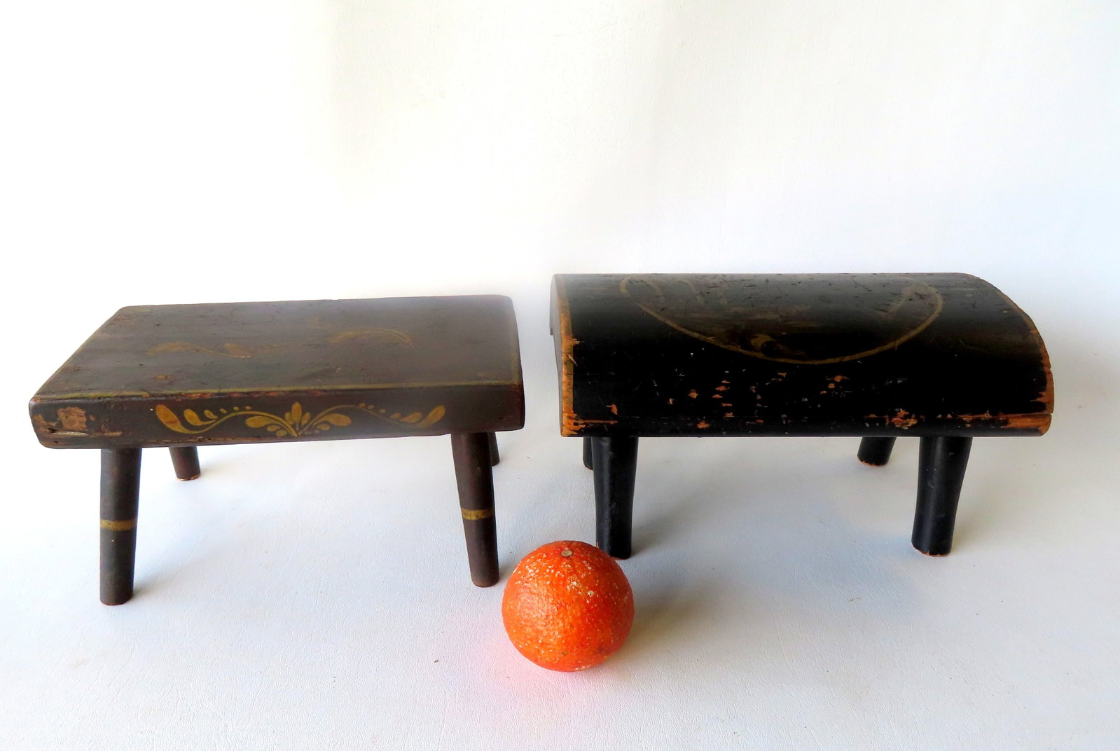 Two Sheraton New England paint decorated cricket stools, one signed on base F.L. Buell. The largest: Two Sheraton New England paint decorated cricket stools, one signed on base F.L. Buell. The largest measures 11 1/2"W x 6 1/2"D x 5 3/4"H. Both early 19th century in original paint and in good conditi