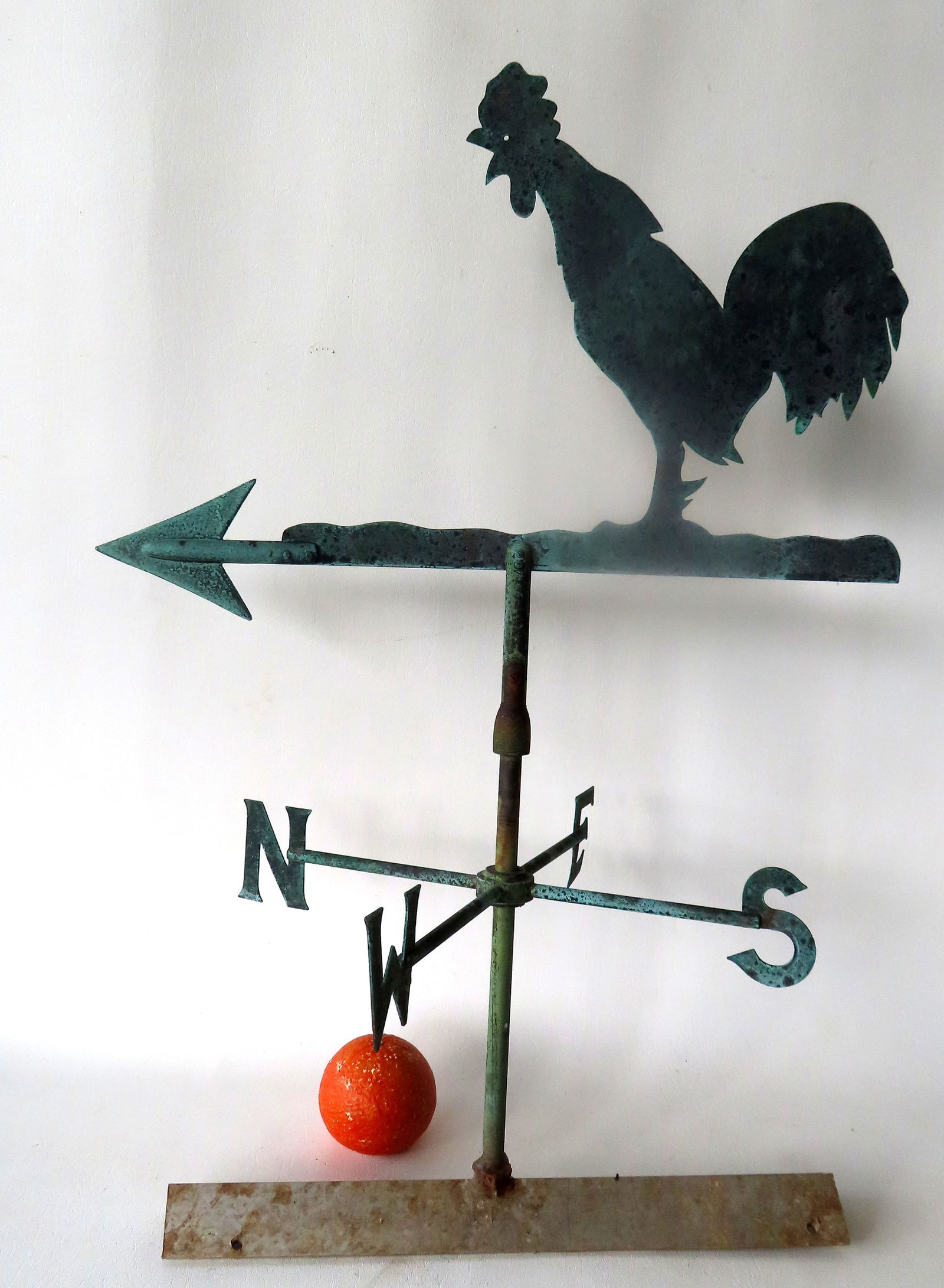 A silhouette copper crowing rooster weathervane mounted on arrow and with original directionals.: A silhouette copper crowing rooster weathervane mounted on arrow and with original directionals. Original green patination, circa early 20th century. Very good condition. The vane itself measures 15"H
