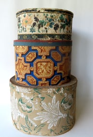 Three hand made wall papered band boxes, all with some staining and in fair to good condition (one
