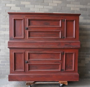 Two stackable primitive cupboards, each with a single door, paneled sides and front, molded base and