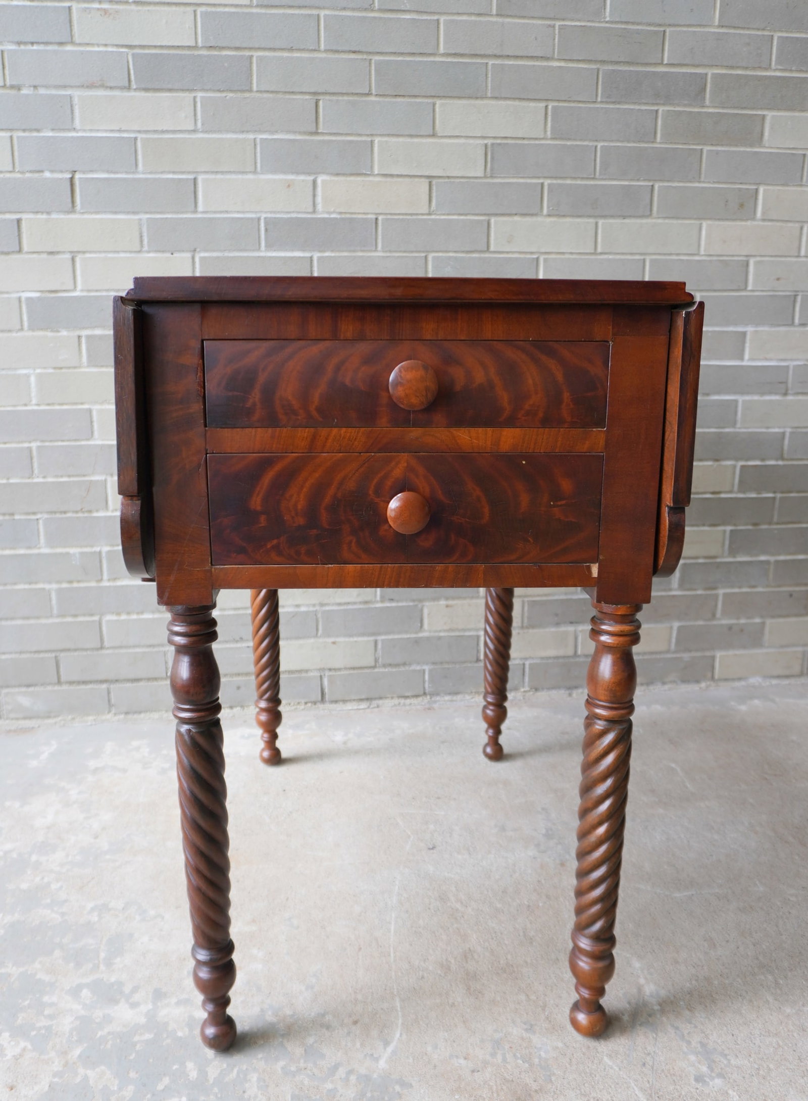 A high quality mahogany dropleaf 4 drawer partner's sewing or game table with 2 drawers each side in: A high quality mahogany dropleaf 4 drawer partner's sewing or game table with 2 drawers each side in figured mahogany. The leaves with shaped corners and the apron also in mahogany and mounted on rope
