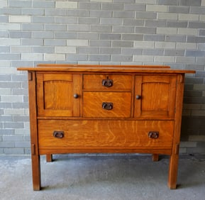 A Mission oak server, refinished with original hardware - likely had a backsplash which is missing.