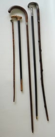 Grouping of 5 vintage walking sticks including: 2 with sterling silver handles (one handle loose,