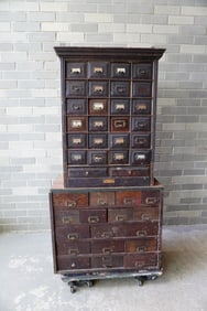 Two wooden utility file cabinets. The first with walnut construction including drawer fronts,