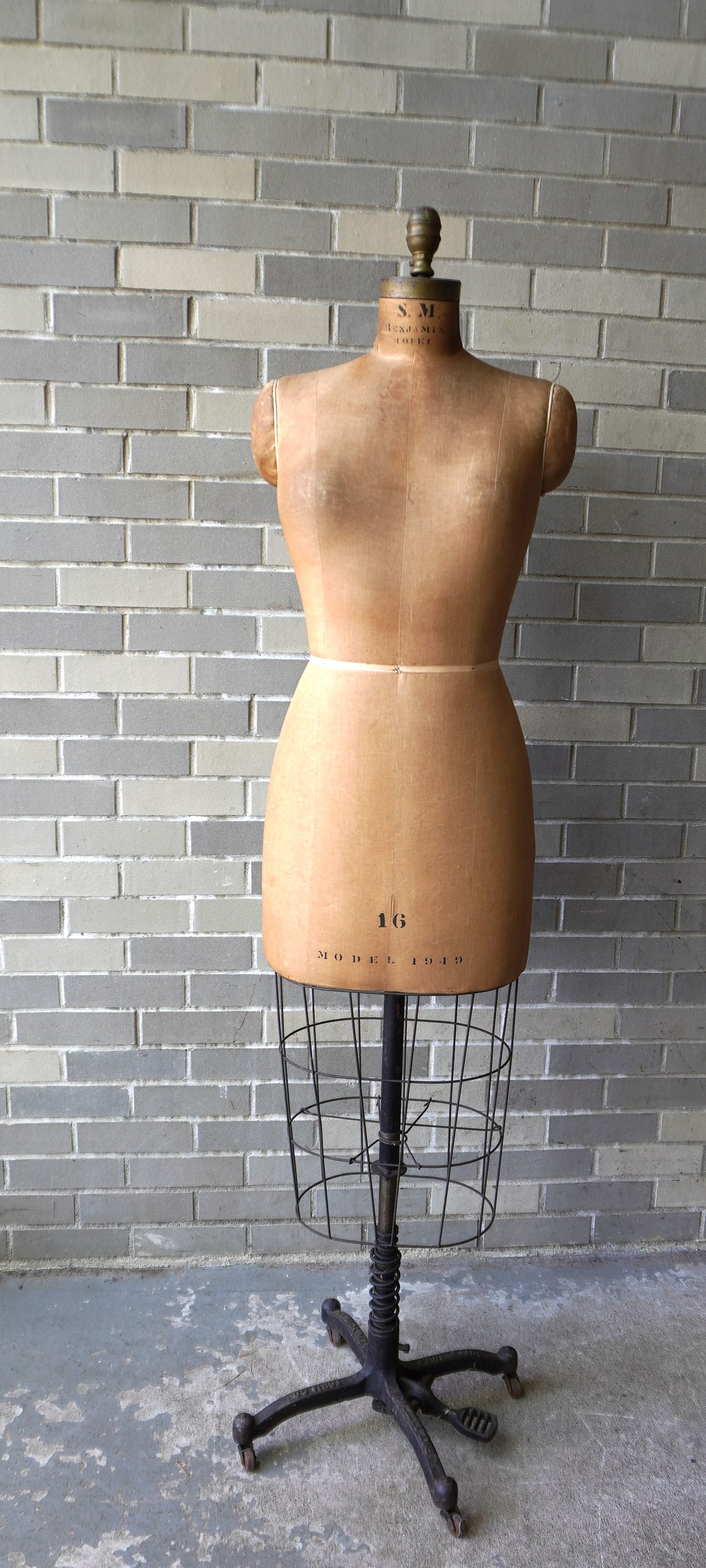 A floor standing adjustable dress form signed on cast iron base "Wolf Model Form Company / New York: A floor standing adjustable dress form signed on cast iron base "Wolf Model Form Company / New York NY" - the form itself in cloth and wire and marked "S.M. Benjamin Model 16 / Model 1949" - minor sta