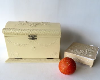 Two ornate dresser boxes. The first in celluloid, with complete set of 5 decorated implements still