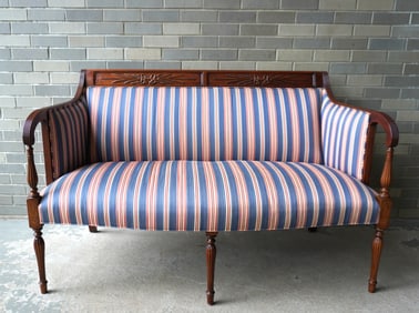 Classical Sheraton style mahogany settee, with relief carved crest, reeded arms leading to reeded