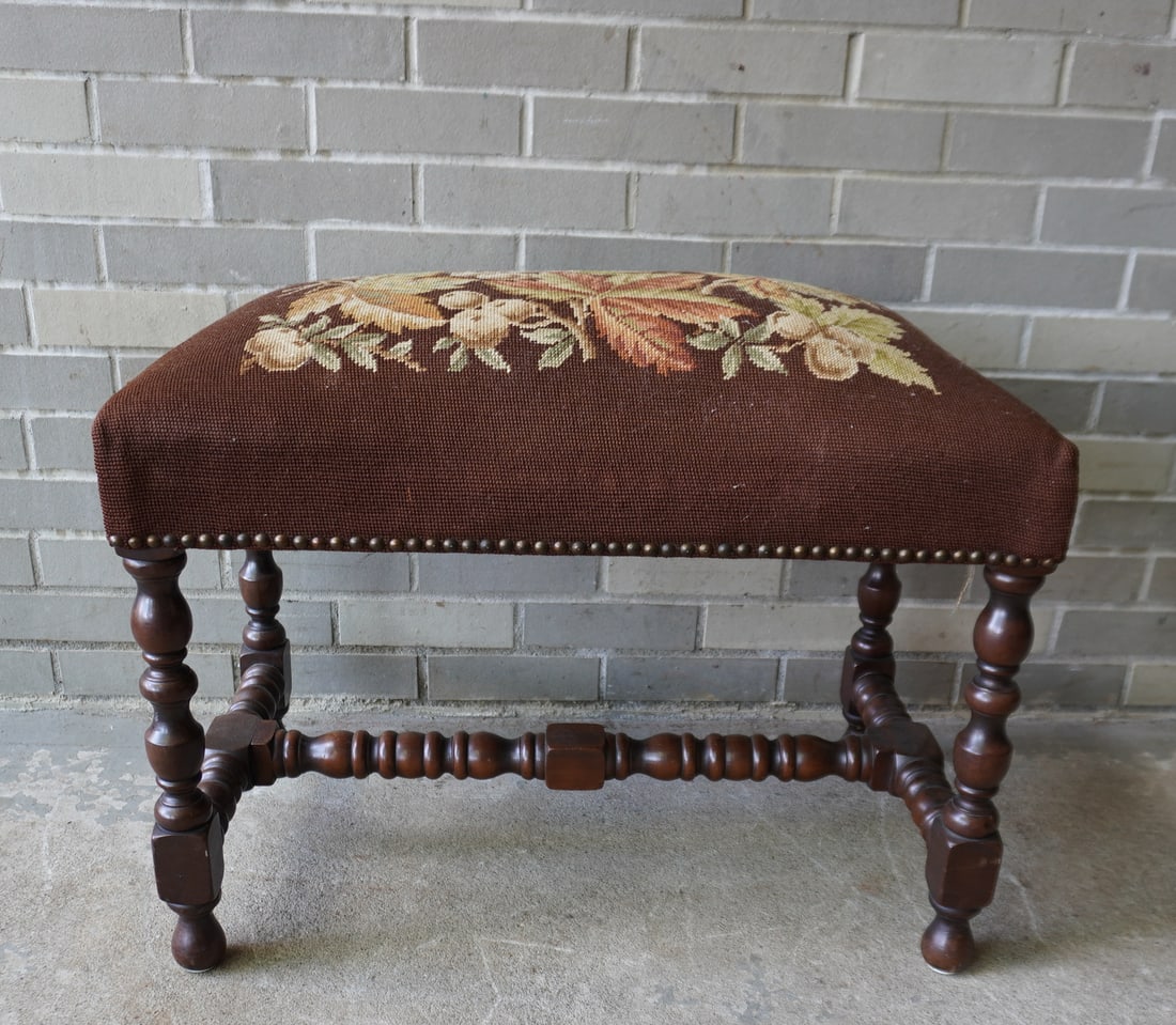 A small needlepoint bench decorated with apples and leaves, hand made in the Jacobean style in black: A small needlepoint bench decorated with apples and leaves, hand made in the Jacobean style in black walnut. Serial number impressed into base as well as "1898" which is likely the date of manufacture