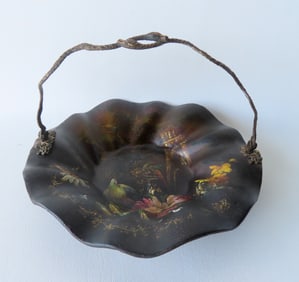 A very fine black lacquered and hand painted candy dish decorated with an exotic bird in bird bath