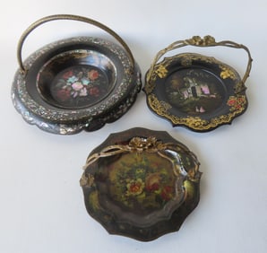 Three ornate black lacquered Victorian candy dishes with fancy swivel handles, 19th century. The