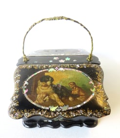 An exceptional black lacquered and paper mache sewing box with 2 lift top compartments with a brass