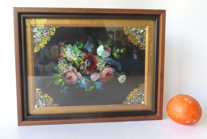 A framed black lacquered paper mache plaque decorated with flowers and mother of pearl inlays, 19th