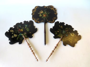 Three Victorian black lacquered paper mache fans with shaped borders decorated with hand painted