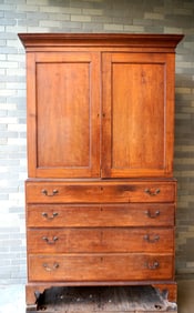 A cherry Chippendale 2 part linen press with cornice over 2 paneled doors over 4 graduated beaded