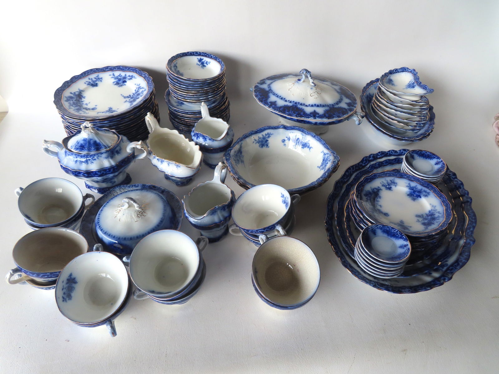 A set of 83 pieces of flow blue china most in the Touraine pattern, by also some similar patterns: A set of 83 pieces of flow blue china most in the Touraine pattern, by also some similar patterns like "Albany", various English makers, late 19th century. Includes 3 platters ranging in size from10 1