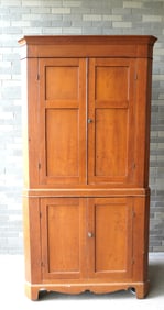 A Hudson Valley 2 part blind door cherry corner cupboard having 2 paneled doors over 2 paneled doors