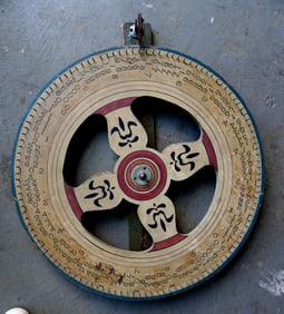 A vintage hand made carnival gaming wheel in original paint, early to mid 20th century. Some typical