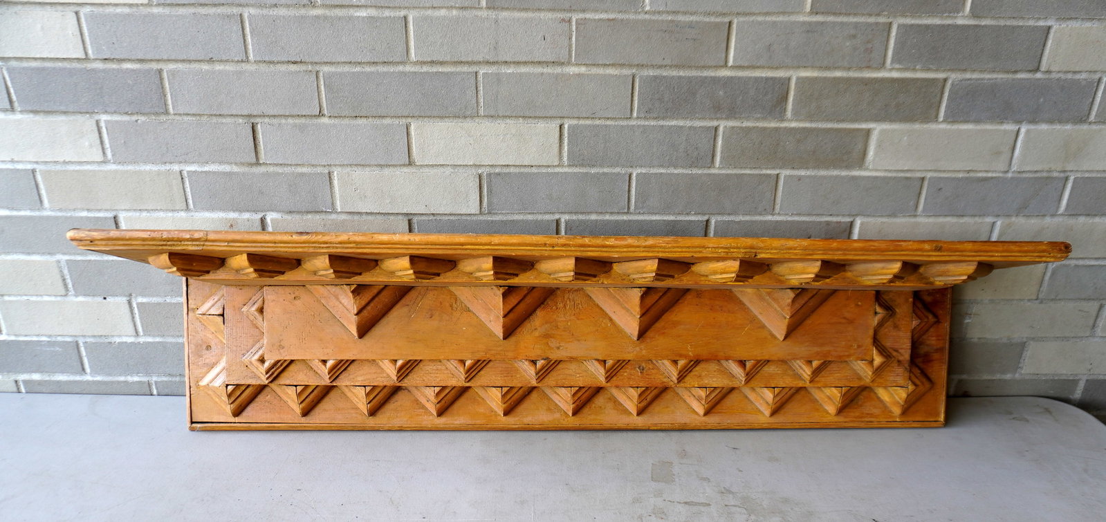 A folk art wall shelf in old paint, 19th century. Measures 46 1/4"W x 9 3/8"D x 10"H. Very good: A folk art wall shelf in old paint, 19th century. Measures 46 1/4"W x 9 3/8"D x 10"H. Very good condition.