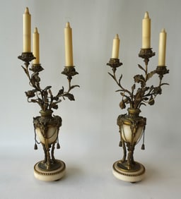 A pair of French Empire neoclassical sculptured candelabras with 3 candle lights supported by