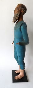 A large carved wooden Santos doll with articulated arms, glass eyes and in original paint, 18th