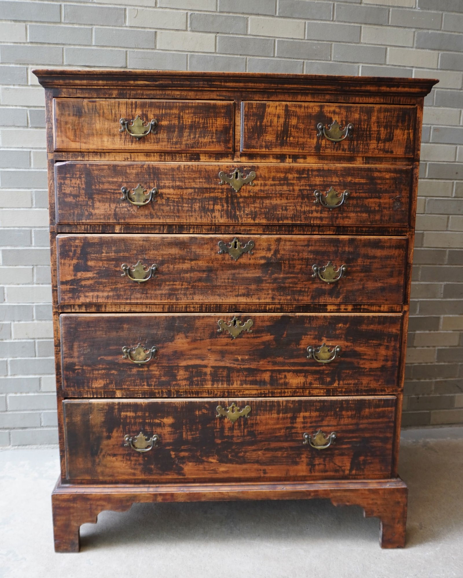 A Chippendale tall chest of drawers in tiger maple, with dovetailed case, 2 short drawers over 4: A Chippendale tall chest of drawers in tiger maple, with dovetailed case, 2 short drawers over 4 graduated drawers (all drawers with beading and dovetail construction), mounted on a good bracket base,