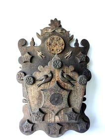 An outstanding American folk art black walnut wall box having a carved backboard with applied flying