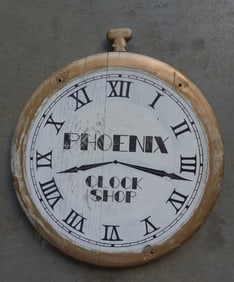 A carved wooden double sided pocket watch trade sign in original paint marked "PHOENIX CLOCK SHOP".