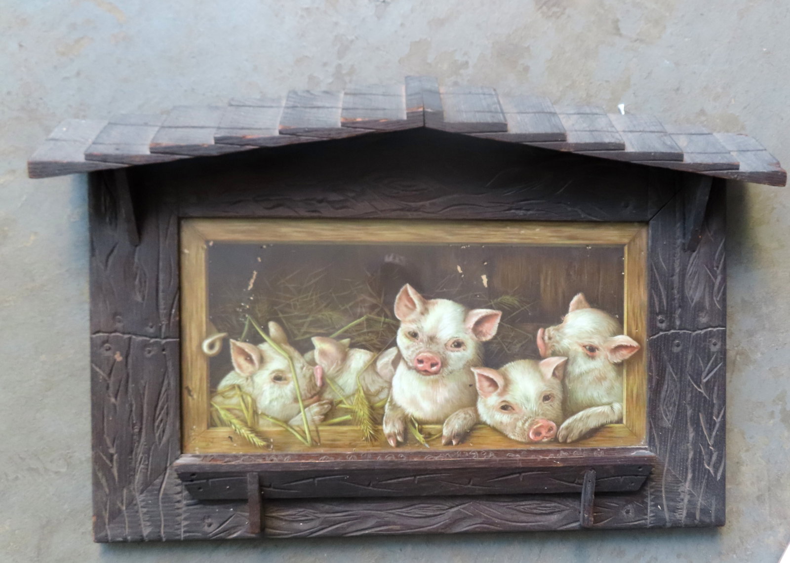 A chromolithograph portrait of 5 piglets at hand made wooden feeding trough which is part of the: A chromolithograph portrait of 5 piglets at hand made wooden feeding trough which is part of the rustic barn-like wooden frame with roof and also decorated with incised vines and flowers. The lithogra