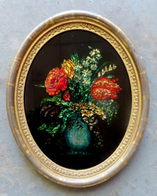 A small oval 19th century tinsel painting depicting flowers in a vase, housed in it's original 19th