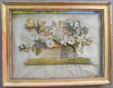 A framed stumpwork embroidery of flowers in a basket, housed in original lemon gold frame, circa