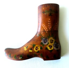 An large carved maple boot mold that has been hand painted with pansies and other flowers as well