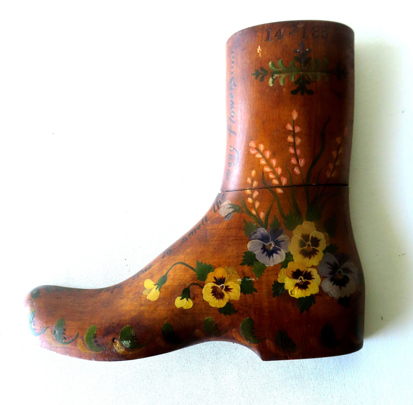 An large carved maple boot mold that has been hand painted with pansies and other flowers as well: An large carved maple boot mold that has been hand painted with pansies and other flowers as well and with a hand painted script inscription that reads "Take time to smell the many flowers..." - curre