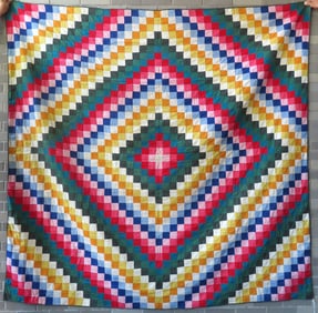 A very colorful patchwork Amish or Mennonite quilt in the "Around the World" pattern, very good