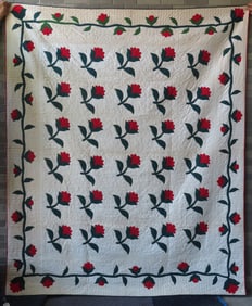 A high quality floral applique quilt, "Tulip" pattern, having a border decorated with flowers on