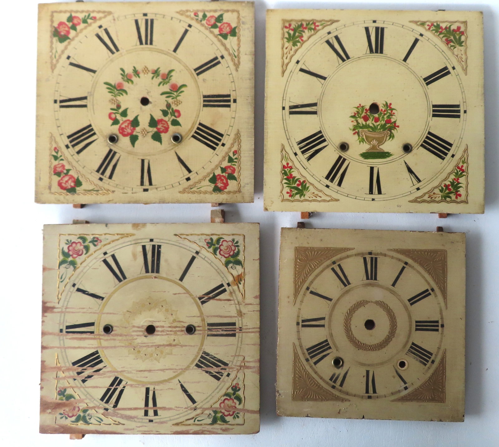 Four hand painted wooden clock faces, mid 19th century or earlier, original paint and in good: Four hand painted wooden clock faces, mid 19th century or earlier, original paint and in good condition. The largest 3 measure approximately 12 1/4" x 11 1/2".