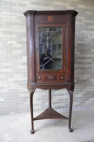 An early mahogany corner cupboard mounted on a later fitted base with pad feet. The cupboard itself