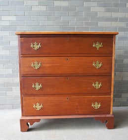 A refinished country cherry dresser having 4 graduated drawers mounted on replaced bracket base, mid