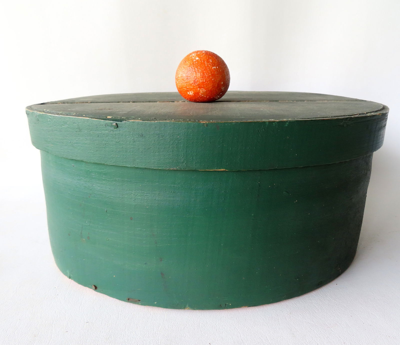 A large wooden cheese box in original green paint, 19th century, good condition. Measures 19": A large wooden cheese box in original green paint, 19th century, good condition. Measures 19" diameter x 7 3/4"H. Provenance: From an Ulster County NY resident, downsizing Americana collection.