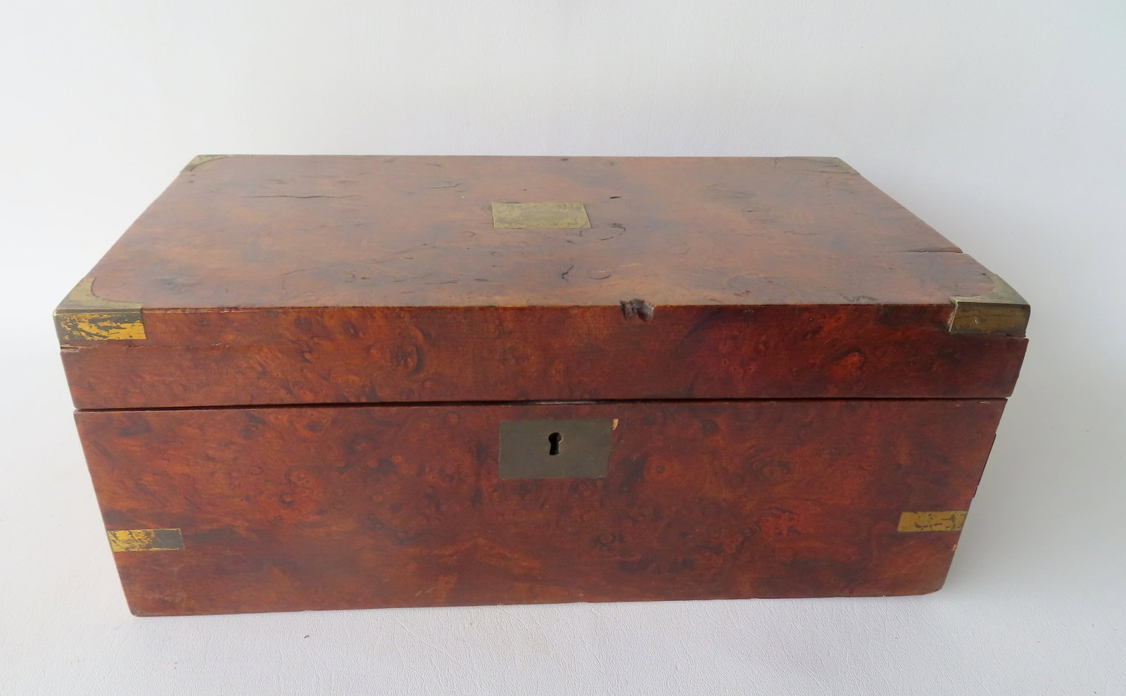A burlwood and rosewood writing box with brass brackets applied to corners, interior tooled leather: A burlwood and rosewood writing box with brass brackets applied to corners, interior tooled leather writing surface and 2 inkwell which are original. Retains original lock, hasp, and key - the locking