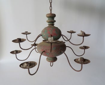 A primitive style ceiling candelabra, 2 tiers of 6 candle fonts attached to a bulbous turned wooden